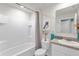 Modern bathroom with a shower, tub, and vanity with decorative accents at 1555 Dawnview Way, Kissimmee, FL 34744