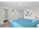 Bright bedroom with a blue comforter set, dresser with mirror, and view into an attached bathroom at 1555 Dawnview Way, Kissimmee, FL 34744