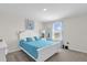 Bright bedroom with a white bed frame, blue bedding, and lots of natural light at 1555 Dawnview Way, Kissimmee, FL 34744