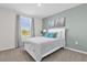 Comfortable bedroom with a white bed frame, soft carpeting, and serene wall decor at 1555 Dawnview Way, Kissimmee, FL 34744