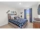Nautical-themed bedroom with a bed, blue accents, and decorative fish artwork at 1555 Dawnview Way, Kissimmee, FL 34744