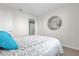 Cozy bedroom with plush bedding, neutral tones, and a decorative mirror at 1555 Dawnview Way, Kissimmee, FL 34744