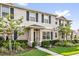 Charming townhome with well-maintained landscaping, a walkway, and a welcoming covered entry at 1555 Dawnview Way, Kissimmee, FL 34744