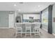Bright kitchen featuring white cabinets, stainless steel appliances, and a breakfast bar with seating at 1555 Dawnview Way, Kissimmee, FL 34744