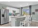 Stylish kitchen with stainless steel appliances, white cabinetry, and a breakfast bar for casual dining at 1555 Dawnview Way, Kissimmee, FL 34744