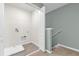 Clean laundry area near the stairs featuring washer hookups and a white drain pan at 1555 Dawnview Way, Kissimmee, FL 34744