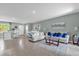 Bright, open-concept living area featuring modern furnishings and neutral decor with colorful accents at 1555 Dawnview Way, Kissimmee, FL 34744