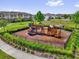 Fenced playground area featuring slides, climbing structures, and green spaces at 1555 Dawnview Way, Kissimmee, FL 34744
