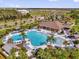 Aerial view of an outdoor pool area with lounge chairs, palm trees, and a covered pavilion at 1555 Dawnview Way, Kissimmee, FL 34744