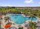 Aerial shot of a community pool featuring lounge chairs and palm trees in a residential area at 1555 Dawnview Way, Kissimmee, FL 34744