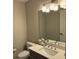 This bathroom includes a toilet and a vanity with a sink at 16300 County Road 455 # 703, Montverde, FL 34756