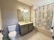 Bathroom with grey vanity, grey paint and white tile at 16300 County Road 455 # 703, Montverde, FL 34756