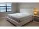 Bright bedroom with lake view and simple furnishings at 16300 County Road 455 # 703, Montverde, FL 34756