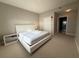 Clean bedroom featuring a closet and view into the bathroom at 16300 County Road 455 # 703, Montverde, FL 34756