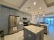 Modern kitchen features stainless steel appliances, gray cabinetry, and a center island with quartz countertops at 16300 County Road 455 # 703, Montverde, FL 34756