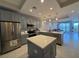 Modern kitchen features stainless steel appliances, gray cabinetry, and a center island with quartz countertops at 16300 County Road 455 # 703, Montverde, FL 34756