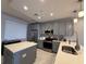 Modern kitchen with gray cabinets, stainless steel appliances, and island with white countertop at 16300 County Road 455 # 703, Montverde, FL 34756