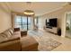 Living room with water view, sectional couch, and modern decor at 16300 County Road 455 # 703, Montverde, FL 34756