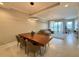 Living and dining area with modern lighting, wood table, and water view at 16300 County Road 455 # 703, Montverde, FL 34756