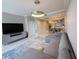 Open-concept living area featuring modern decor, tv, and kitchen in the background at 16300 County Road 455 # 703, Montverde, FL 34756