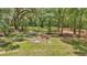 Exterior image of a firepit surrounded by mature trees at 16758 Ne 135Th Ave, Fort Mc Coy, FL 32134