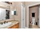 Bathroom vanity with granite counters, decorative light fixtures and a mirrored medicine cabinet at 16758 Ne 135Th Ave, Fort Mc Coy, FL 32134