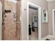 Bathroom featuring a tiled walk-in shower with a sleek black shower head and built-in shelving at 16758 Ne 135Th Ave, Fort Mc Coy, FL 32134