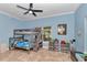 Blue bedroom with a bunk bed, fan, and decorative lion artwork on the wall at 16758 Ne 135Th Ave, Fort Mc Coy, FL 32134