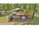 A shed and lean-to sit on a grassy lot surrounded by woods at 16758 Ne 135Th Ave, Fort Mc Coy, FL 32134