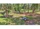 Exterior image of a patio table surrounded by mature trees at 16758 Ne 135Th Ave, Fort Mc Coy, FL 32134