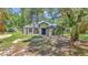 Well-maintained single story home featuring arched windows, covered entry, and a verdant front lawn at 16758 Ne 135Th Ave, Fort Mc Coy, FL 32134
