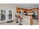 This kitchen features a breakfast bar, wood cabinets, and stainless steel appliances at 16758 Ne 135Th Ave, Fort Mc Coy, FL 32134