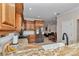Kitchen with granite countertops, stainless steel appliances, and view into the comfortable living room at 16758 Ne 135Th Ave, Fort Mc Coy, FL 32134