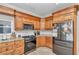Traditional kitchen featuring wood cabinets, granite countertops, and stainless steel appliances at 16758 Ne 135Th Ave, Fort Mc Coy, FL 32134