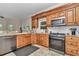 Well-equipped kitchen with wooden cabinets, granite counters, and stainless steel appliances at 16758 Ne 135Th Ave, Fort Mc Coy, FL 32134