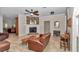 Cozy living room featuring a fireplace, leather furniture, and views into the kitchen area at 16758 Ne 135Th Ave, Fort Mc Coy, FL 32134