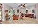 Spacious living room with comfortable seating, tiled floors, and a bright, airy atmosphere at 16758 Ne 135Th Ave, Fort Mc Coy, FL 32134