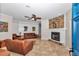 Living room features a cozy fireplace, comfortable leather seating, and neutral decor at 16758 Ne 135Th Ave, Fort Mc Coy, FL 32134