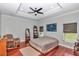 Comfortable main bedroom featuring hardwood floors, a ceiling fan, and plenty of natural light at 16758 Ne 135Th Ave, Fort Mc Coy, FL 32134