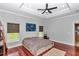 Cozy main bedroom featuring hardwood floors, recessed lighting, ceiling fan, and large windows at 16758 Ne 135Th Ave, Fort Mc Coy, FL 32134