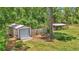 An aerial view showing the property's outbuildings, including a garage and animal pen at 16758 Ne 135Th Ave, Fort Mc Coy, FL 32134
