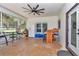 Covered patio with a fan, refrigerator, bar, and screen window overlooking the yard at 16758 Ne 135Th Ave, Fort Mc Coy, FL 32134