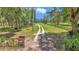 Long driveway leads to this picturesque property lined with trees and fencing at 16758 Ne 135Th Ave, Fort Mc Coy, FL 32134