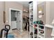 Organized walk-in closet with built-in shelving and clothing racks, adjacent to a laundry area at 16758 Ne 135Th Ave, Fort Mc Coy, FL 32134
