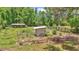 Aerial view showcasing a garden and several animal pens surrounded by lush green grass and fencing at 16758 Ne 135Th Ave, Fort Mc Coy, FL 32134