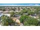 Aerial view of a residential neighborhood featuring townhomes, lush greenery, and a community pond at 1806 Foxhall Cir # 1806, Kissimmee, FL 34741