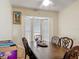 Cozy dining area featuring a dark wood table, chairs, and natural light at 1806 Foxhall Cir # 1806, Kissimmee, FL 34741
