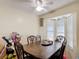 Dining area with a dark wood table, ornate chairs, and natural light from the window at 1806 Foxhall Cir # 1806, Kissimmee, FL 34741