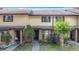 Charming townhome exterior with brick accents, lush landscaping, and inviting entrance at 1806 Foxhall Cir # 1806, Kissimmee, FL 34741