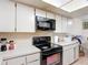Close-up of the kitchen appliances and white countertops at 1806 Foxhall Cir # 1806, Kissimmee, FL 34741